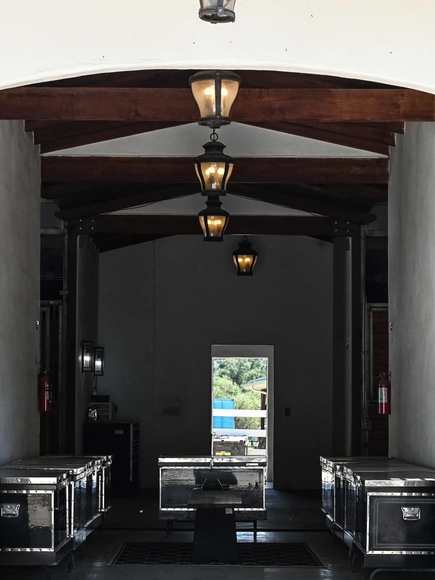 The barn aisle at 21 Mile Ranch with iron lanterns and show trunks